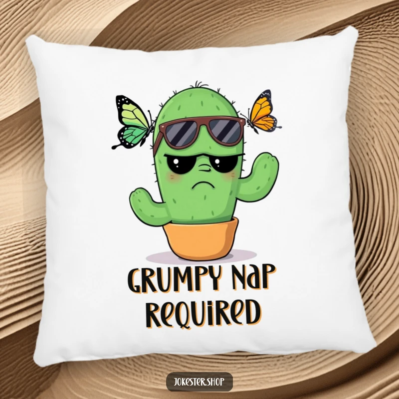 Funny Pillow: A soft cushion featuring a grumpy cactus in sunglasses, looking annoyed by a butterfly, offering a humorous and comfortable accent piece.