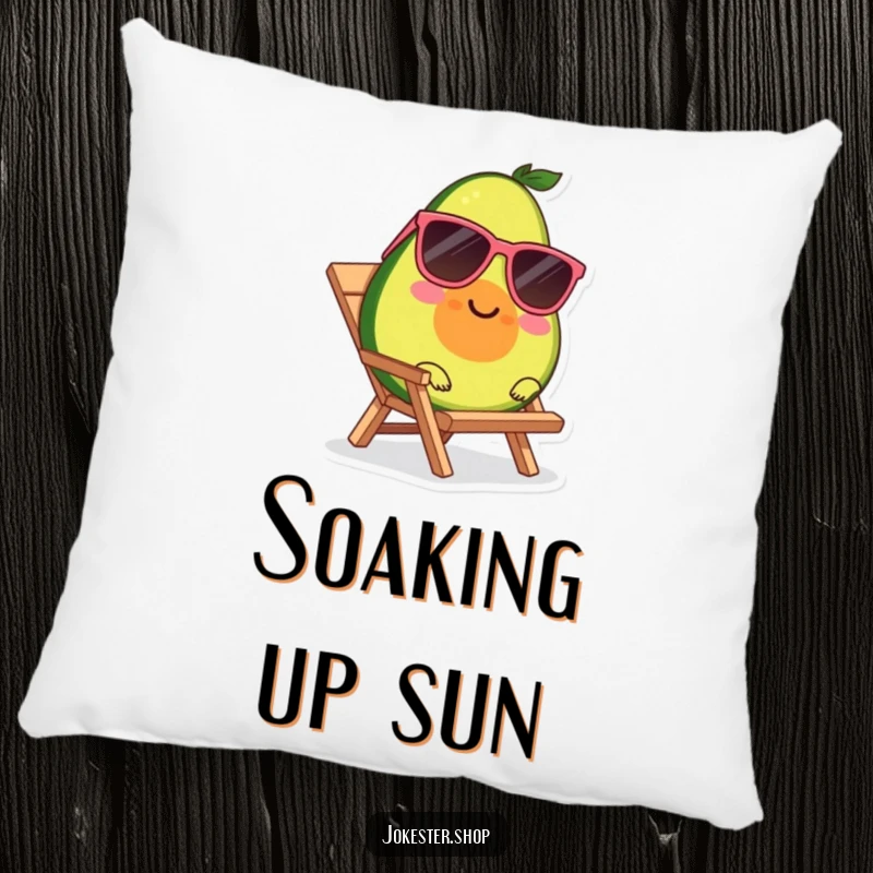 Funny decorative pillow with a smiling avocado wearing sunglasses, relaxing on a tiny beach chair.