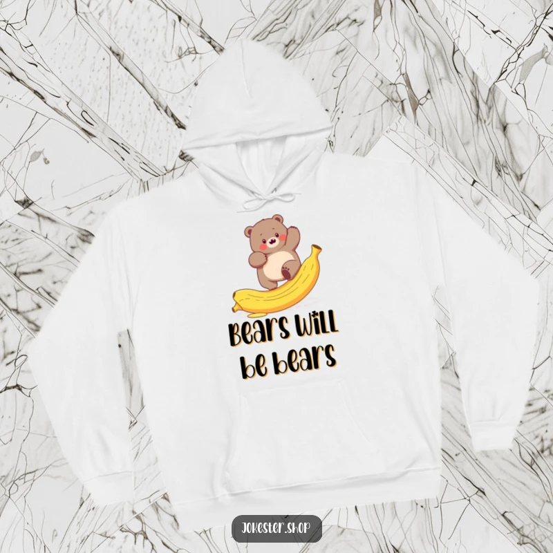 Funny hoodie with a plump bear hilariously attempting to climb a slippery banana peel, a cozy woodland scene.