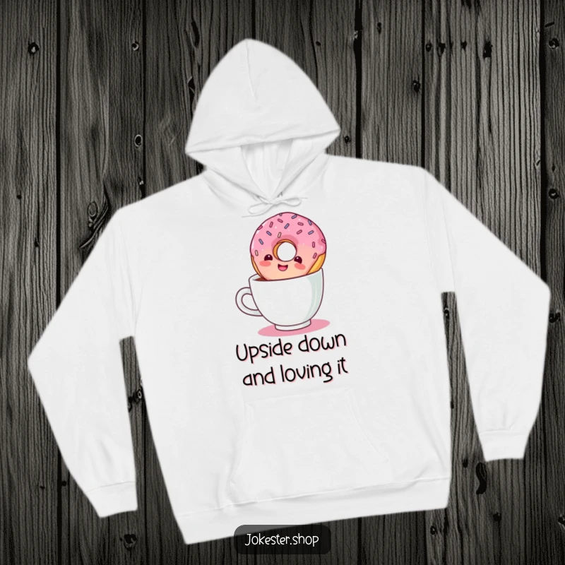 Funny hoodie design showing a giggling donut with sprinkles taking an inverted plunge into a coffee cup.