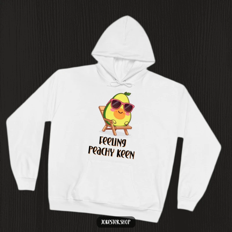 Funny, cozy hoodie featuring a smiling avocado wearing sunglasses, relaxing on a tiny beach chair.