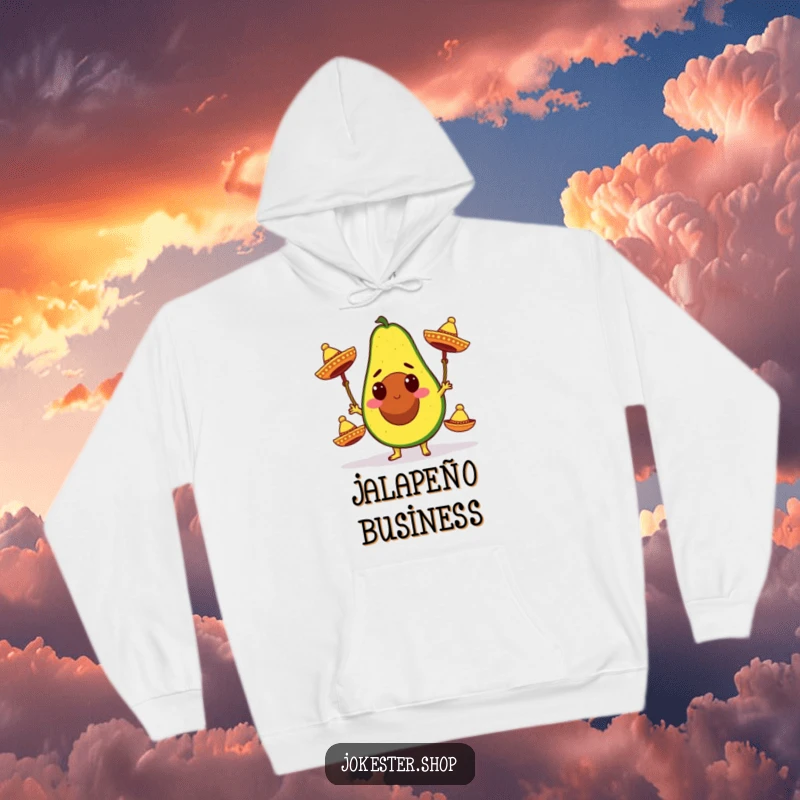 Funny hoodie showcasing a determined avocado character in the act of juggling three colorful miniature sombreros, perfect for festive occasions.