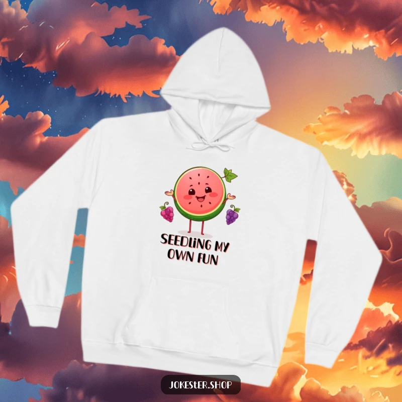 Funny hoodie depicting a beaming watermelon slice in mid-air, juggling three tiny grapes with impressive skill, bringing smiles.