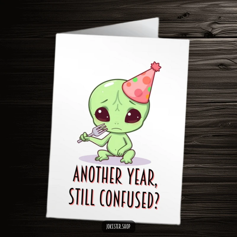 Funny Free Printable Birthday Card: Confused alien in party hat attempts to eat fork, a hilarious DIY gift.
