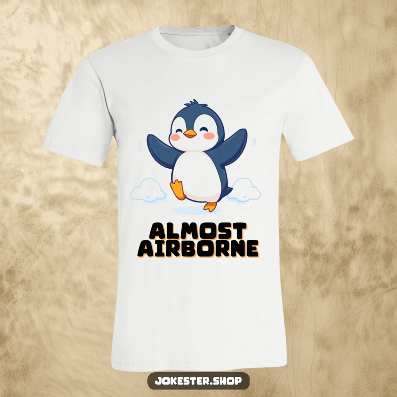 Funny T-Shirt depicting a determined penguin trying to fly with its flippers, embodying humor and perseverance.