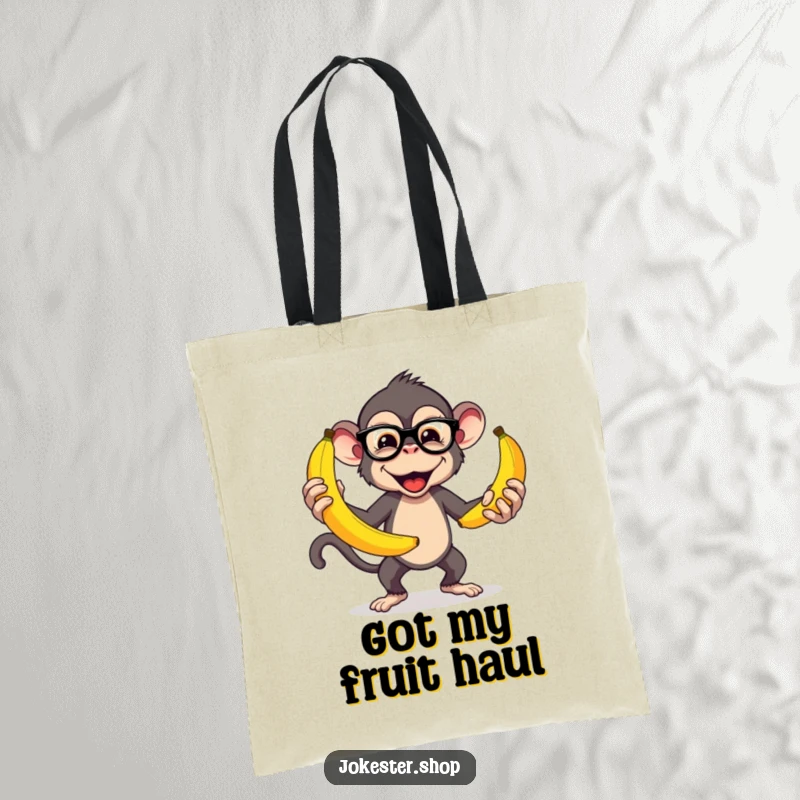 Funny tote bag with a mischievous monkey wearing glasses, juggling large bananas, ideal for carrying daily items with a humorous flair.